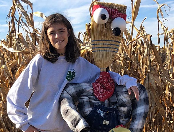Photo of 4Her with scarecrow