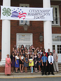 Citizenship Washington Focus participants standing under a banner than says 'Citizen Washington Focus'.