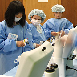 Three 4-H'ers in lab coats.