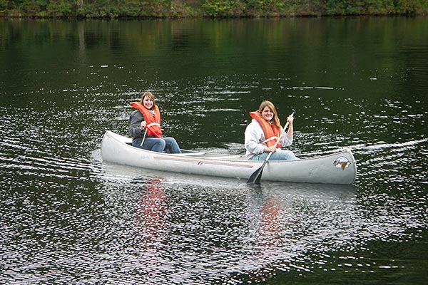 Two 4-H'ers paddling in a canoe.