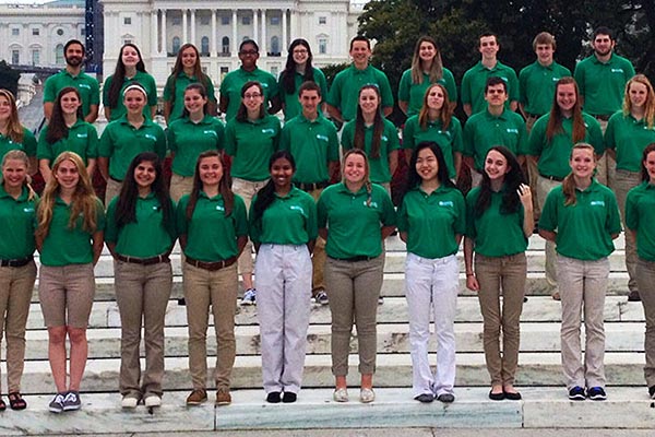 A large group of 4-H'ers posing for a picture in front of the Capitol building in Washington, DC.